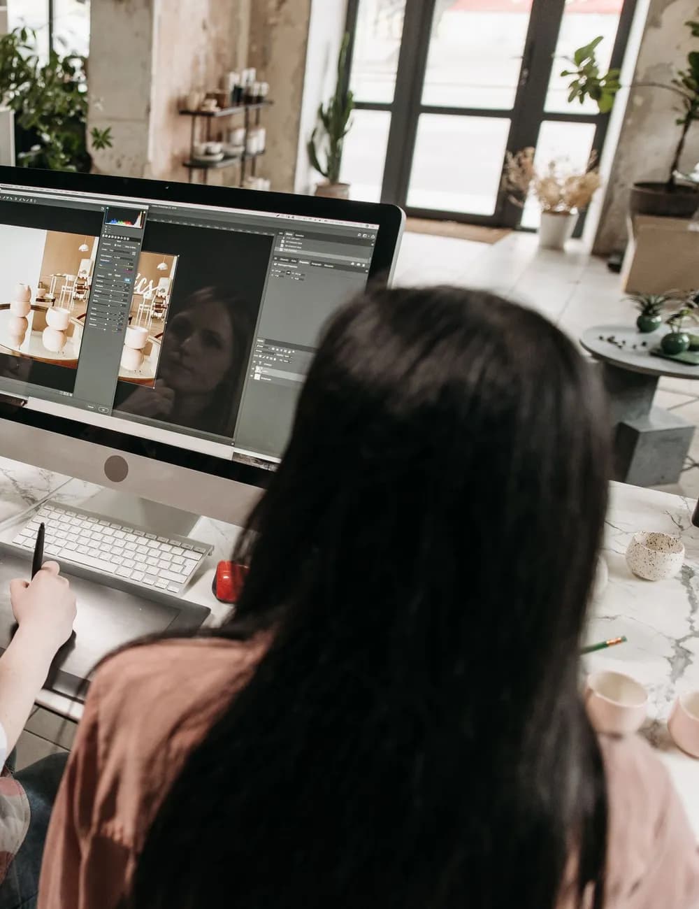 A small creative team reviewing a design together at a studio desk